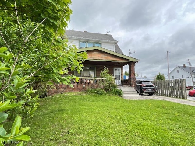 rear view of house featuring covered porch and driveway