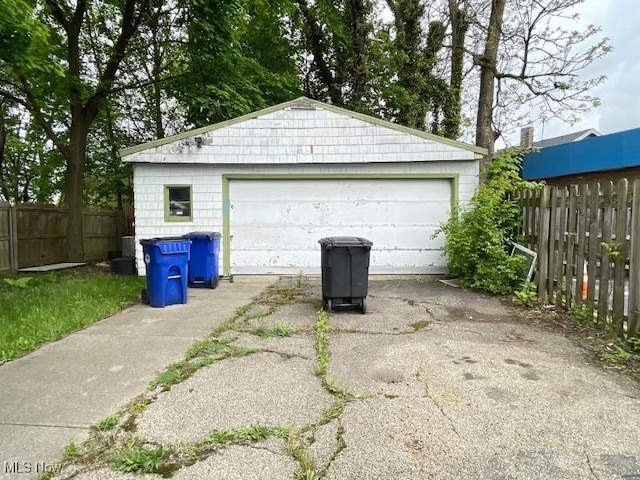 detached garage featuring fence