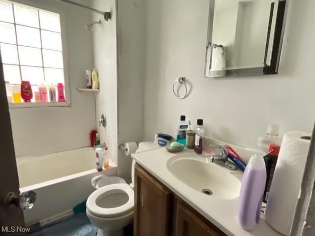 full bath featuring toilet, vanity, and shower / bathtub combination