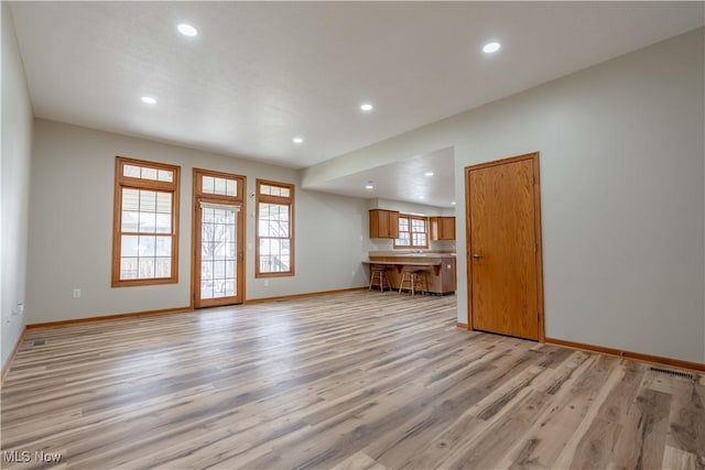 847 Beverly Ave, Canal Fulton, OH 44614 - unfurnished living room featuring recessed lighting, light wood-type flooring, and baseboards