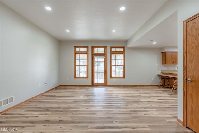 847 Beverly Ave, Canal Fulton, OH 44614 - unfurnished living room featuring light wood-type flooring, baseboards, and recessed lighting