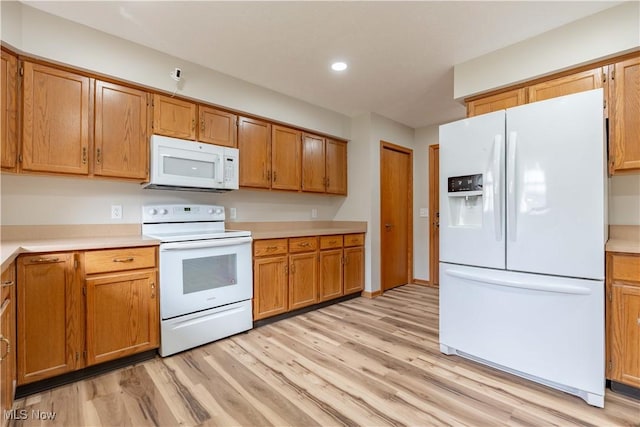 847 Beverly Ave, Canal Fulton, OH 44614 - kitchen with white appliances, light wood finished floors, light countertops, brown cabinets, and recessed lighting