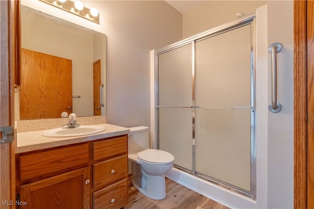 847 Beverly Ave, Canal Fulton, OH 44614 - full bathroom featuring toilet, a shower stall, vanity, and wood finished floors