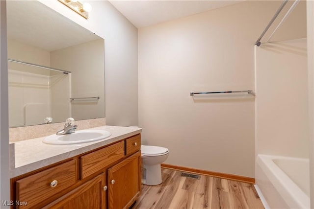 847 Beverly Ave, Canal Fulton, OH 44614 - bathroom with wood finished floors, toilet, vanity, and baseboards