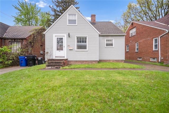 4194 W 140th St, Cleveland, OH 44135 - back of house with a chimney, a lawn, a shingled roof, and entry steps