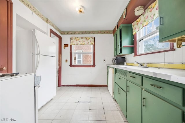 4194 W 140th St, Cleveland, OH 44135 - kitchen with green cabinets, light countertops, white appliances, baseboards, and a sink