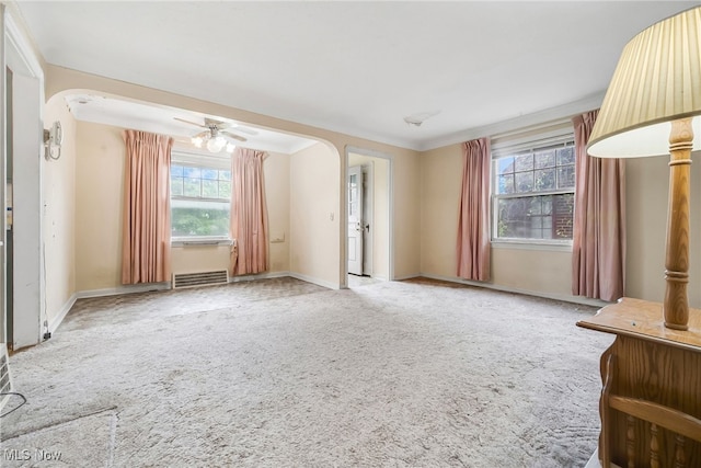 4194 W 140th St, Cleveland, OH 44135 - carpeted spare room featuring arched walkways, baseboards, and a ceiling fan
