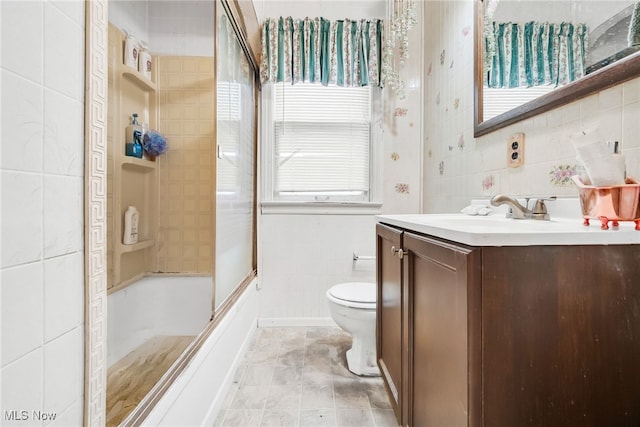 4194 W 140th St, Cleveland, OH 44135 - full bathroom featuring tile walls, vanity, toilet, and bath / shower combo with glass door