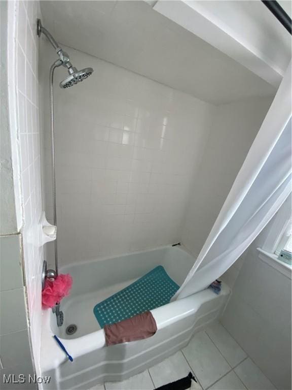 full bathroom featuring shower / bath combo with shower curtain and tile patterned flooring