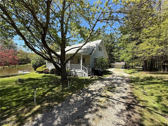 5123 Hemlock Ln, Harpersfield, OH 44041 - view of home's exterior with driveway, covered porch, a lawn, and a water view