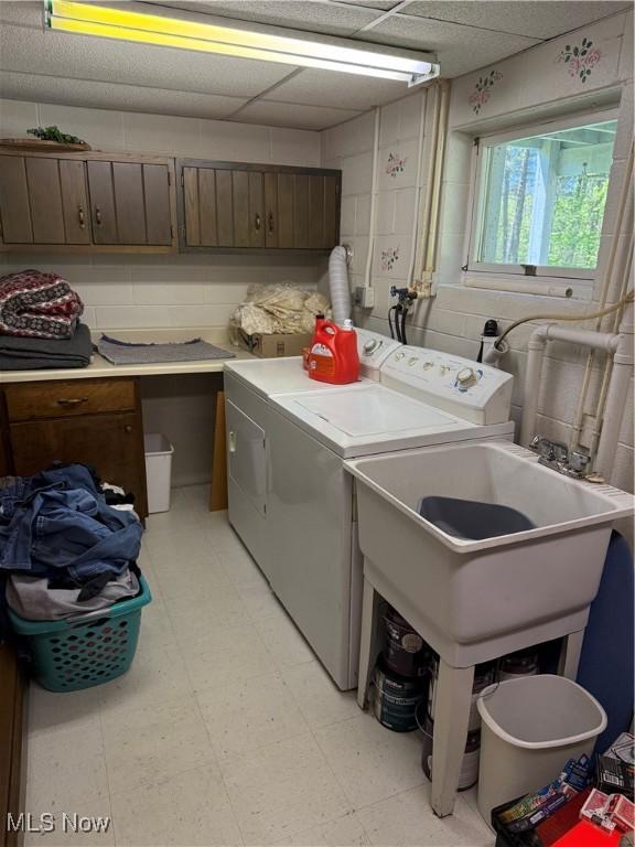 5123 Hemlock Ln, Harpersfield, OH 44041 - laundry room featuring washing machine and dryer, cabinet space, and light flooring