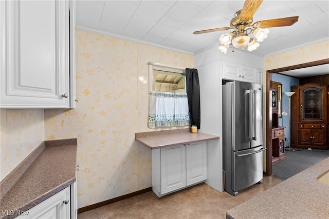 kitchen featuring high end refrigerator, white cabinets, a ceiling fan, light colored carpet, and baseboards