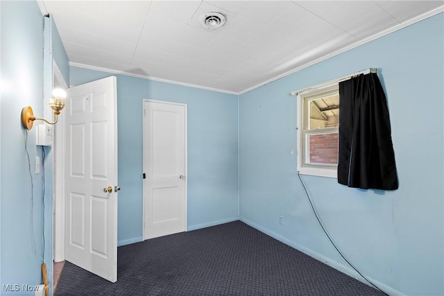 unfurnished bedroom featuring carpet floors, ornamental molding, and baseboards