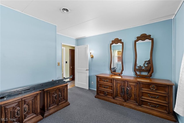 bedroom with dark carpet and ornamental molding