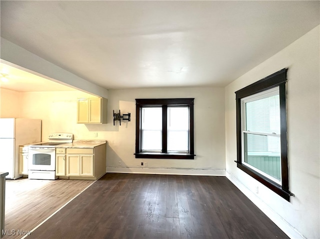 unfurnished dining area featuring wood finished floors and baseboards