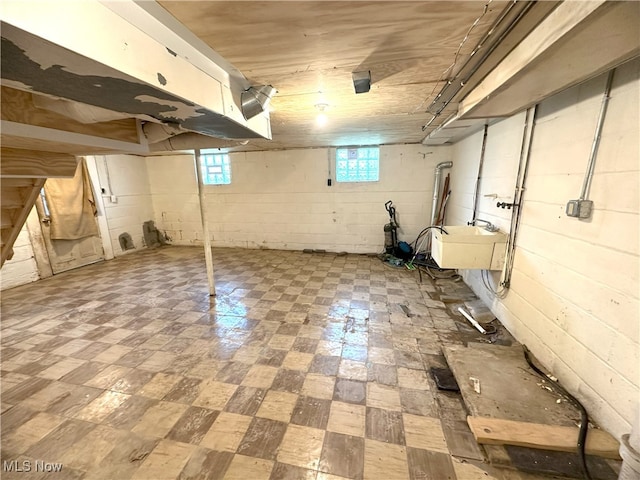 below grade area with tile patterned floors and a sink