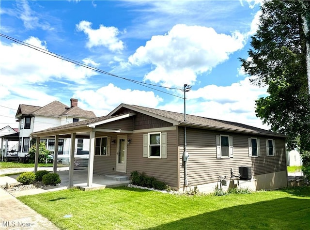 102 Maple, Bethesda, OH 43719 - view of front of home with a front lawn, central AC, and a carport