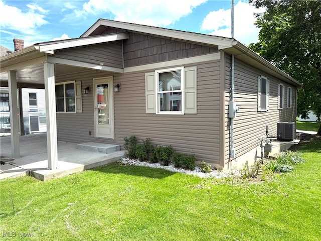 102 Maple, Bethesda, OH 43719 - view of front of home with a front lawn and central AC