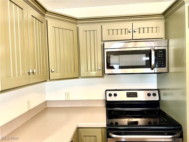 102 Maple, Bethesda, OH 43719 - kitchen featuring stainless steel appliances, light countertops, and cream cabinets