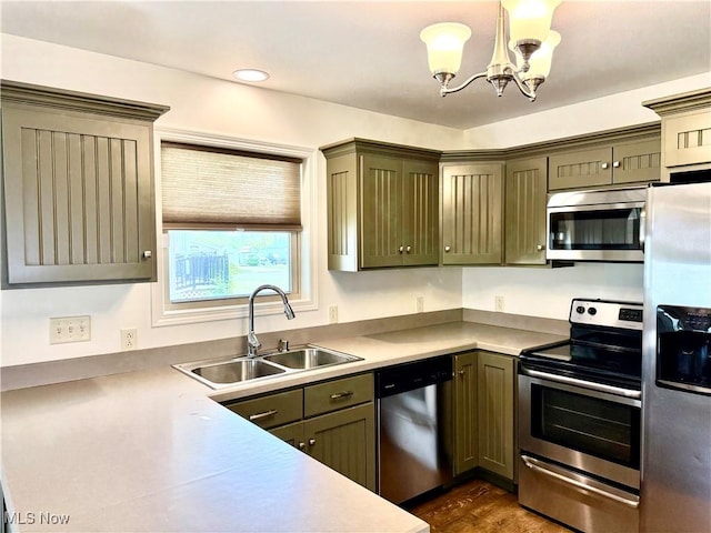 102 Maple, Bethesda, OH 43719 - kitchen with appliances with stainless steel finishes, a sink, a chandelier, light countertops, and dark wood-style floors