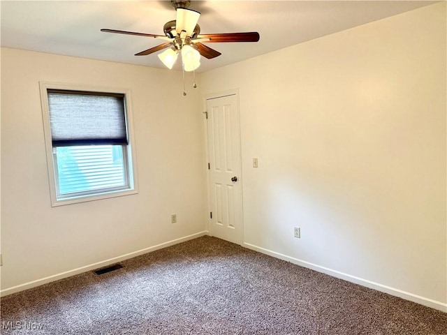 102 Maple, Bethesda, OH 43719 - spare room featuring dark carpet, ceiling fan, and baseboards