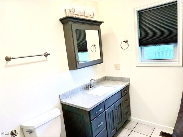 102 Maple, Bethesda, OH 43719 - bathroom featuring vanity, toilet, baseboards, and tile patterned flooring
