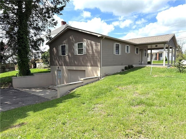 102 Maple, Bethesda, OH 43719 - back of house featuring asphalt driveway, a yard, a garage, and a chimney