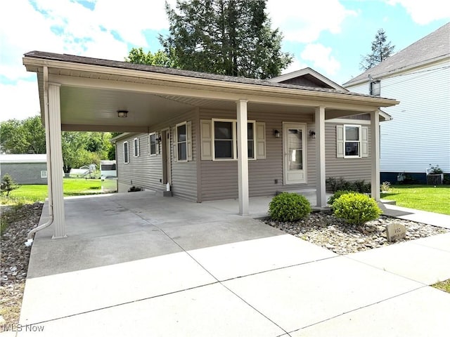 102 Maple, Bethesda, OH 43719 - view of front facade with a carport and driveway