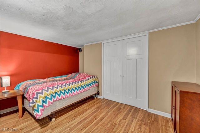 3475 Clague Rd, North Olmsted, OH 44070 - bedroom featuring wood finished floors, baseboards, a closet, and crown molding