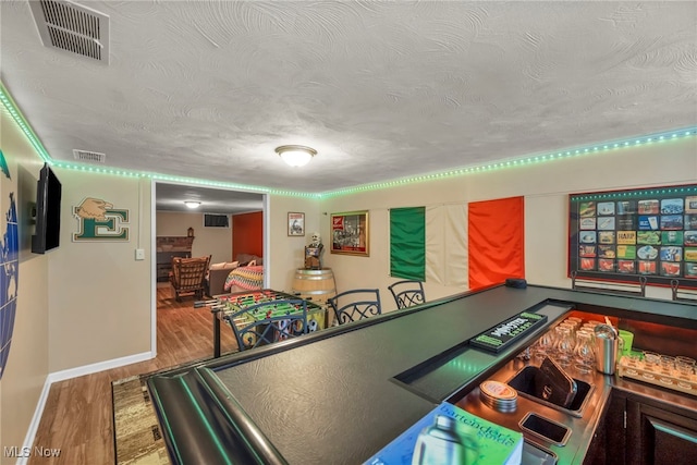 3475 Clague Rd, North Olmsted, OH 44070 - game room with wood finished floors, baseboards, and a textured ceiling