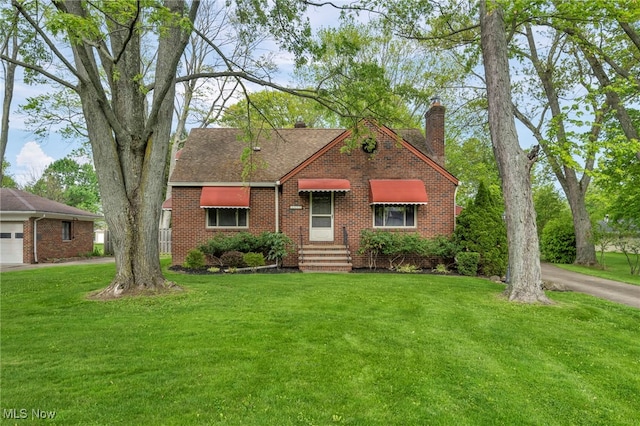 3475 Clague Rd, North Olmsted, OH 44070 - view of front of house featuring a chimney, brick siding, a front yard, a garage, and a shingled roof