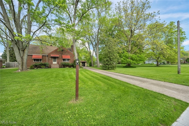 3475 Clague Rd, North Olmsted, OH 44070 - view of front facade with a front lawn, brick siding, a chimney, and a garage