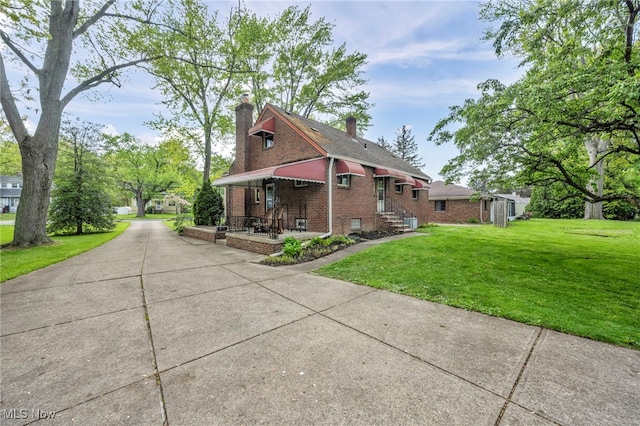 3475 Clague Rd, North Olmsted, OH 44070 - view of home's exterior with brick siding, a yard, and a chimney