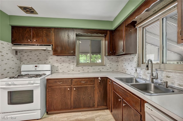 3475 Clague Rd, North Olmsted, OH 44070 - kitchen featuring white appliances, under cabinet range hood, a sink, and light countertops