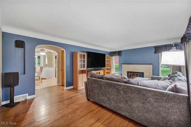 3475 Clague Rd, North Olmsted, OH 44070 - living area with healthy amount of natural light, crown molding, wood finished floors, arched walkways, and baseboards