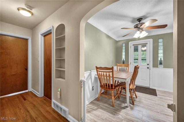 3475 Clague Rd, North Olmsted, OH 44070 - dining area featuring ceiling fan, arched walkways, wood finished floors, built in features, and baseboards