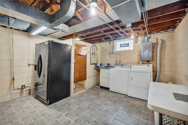3475 Clague Rd, North Olmsted, OH 44070 - basement featuring electric panel, black fridge, and washing machine and clothes dryer