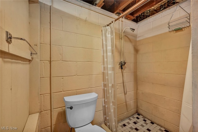 3475 Clague Rd, North Olmsted, OH 44070 - bathroom with a shower stall, concrete block wall, and toilet