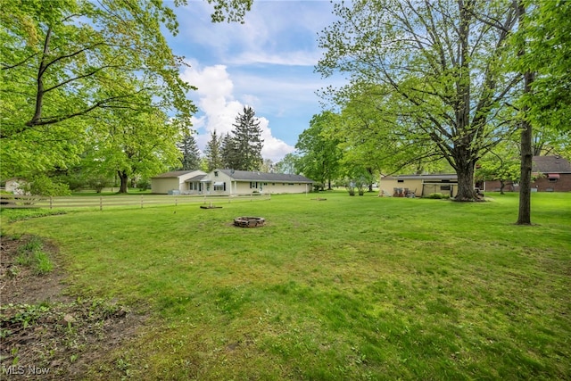 3475 Clague Rd, North Olmsted, OH 44070 - view of grassy yard with an outdoor fire pit