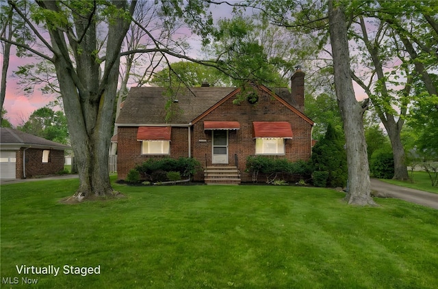 3475 Clague Rd, North Olmsted, OH 44070 - tudor home featuring brick siding, a chimney, and a front lawn