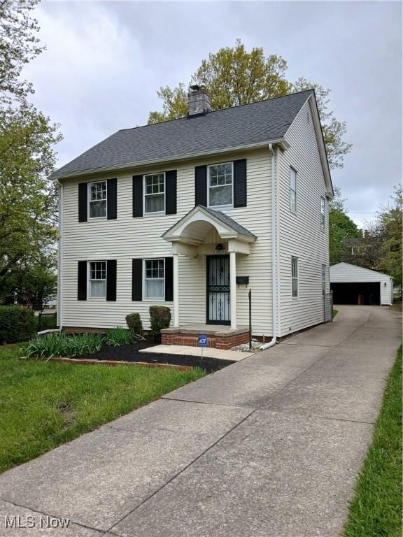 3609 Stoer Rd, Shaker Heights, OH 44122 - colonial home with an outdoor structure, a chimney, roof with shingles, and a garage