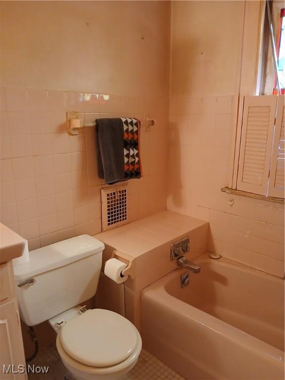 3609 Stoer Rd, Shaker Heights, OH 44122 - full bathroom featuring tile walls, vanity, and a tub to relax in