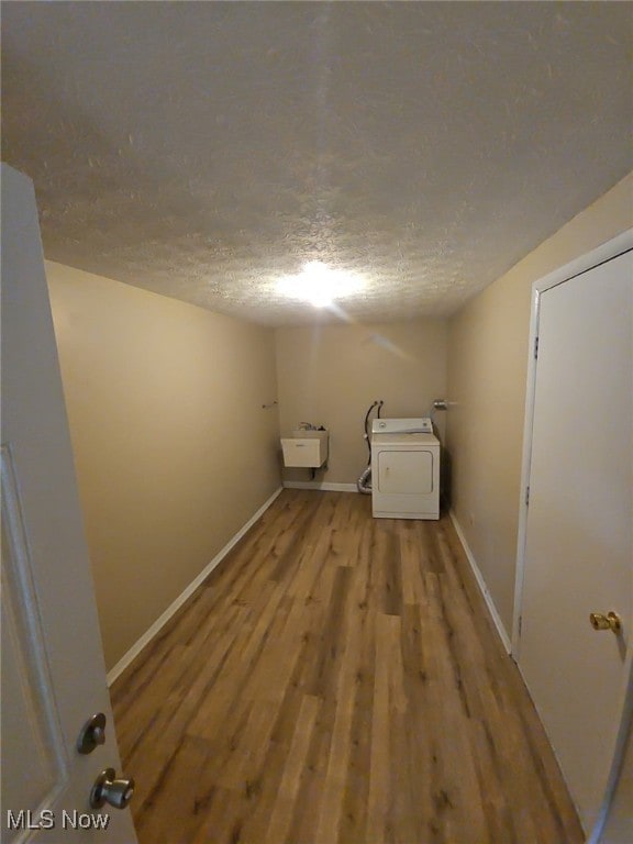681 Longcoy Ave, Kent, OH 44240 - laundry area featuring washer / dryer, wood finished floors, baseboards, a textured ceiling, and a sink