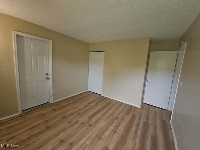 681 Longcoy Ave, Kent, OH 44240 - spare room with wood finished floors, baseboards, and a textured ceiling