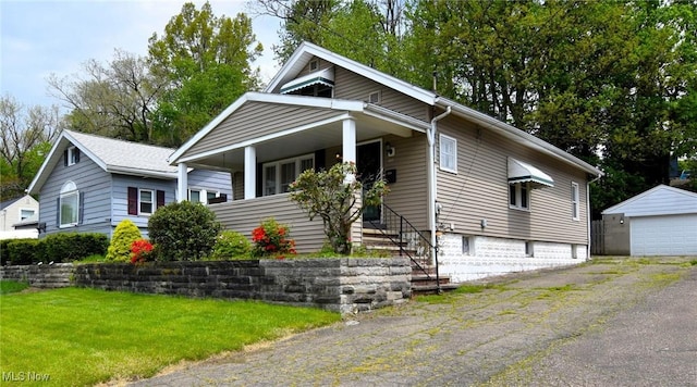 1255 Gorge Blvd, Akron, OH 44310 - bungalow-style home with a detached garage, an outdoor structure, and a front yard