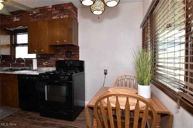 1255 Gorge Blvd, Akron, OH 44310 - kitchen featuring black appliances, a sink, dark wood-style floors, light countertops, and a chandelier