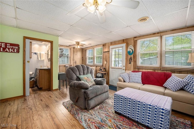 5755 Lake Rd W Unit 6, Ashtabula, OH 44004 - living room featuring ceiling fan, a drop ceiling, light wood-style flooring, and baseboards