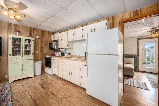 5755 Lake Rd W Unit 6, Ashtabula, OH 44004 - kitchen featuring white appliances, a paneled ceiling, a ceiling fan, wooden walls, and light wood-style floors