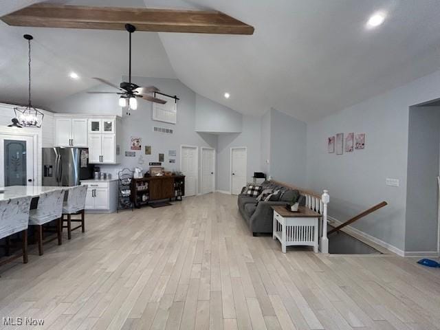 4718 Brushwood Rd, Wakeman, OH 44889 - living area with high vaulted ceiling, ceiling fan, light wood-type flooring, beam ceiling, and baseboards