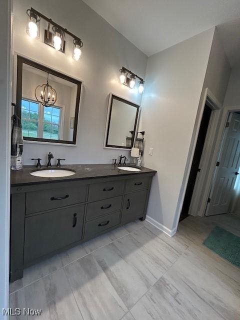 4718 Brushwood Rd, Wakeman, OH 44889 - full bath featuring a chandelier, double vanity, and baseboards